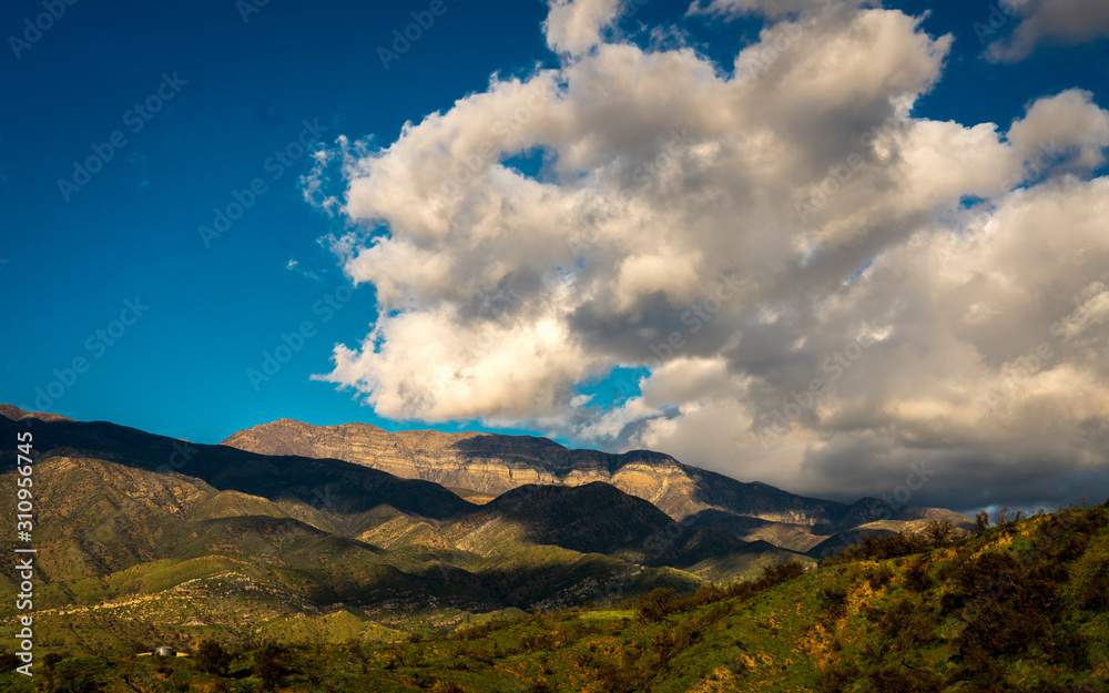 Fototapeta premium MARCH 7, 2019, MALIBU, LA, CA, USA - Mountainous landscape of Ojai with greenfields and sunset clouds