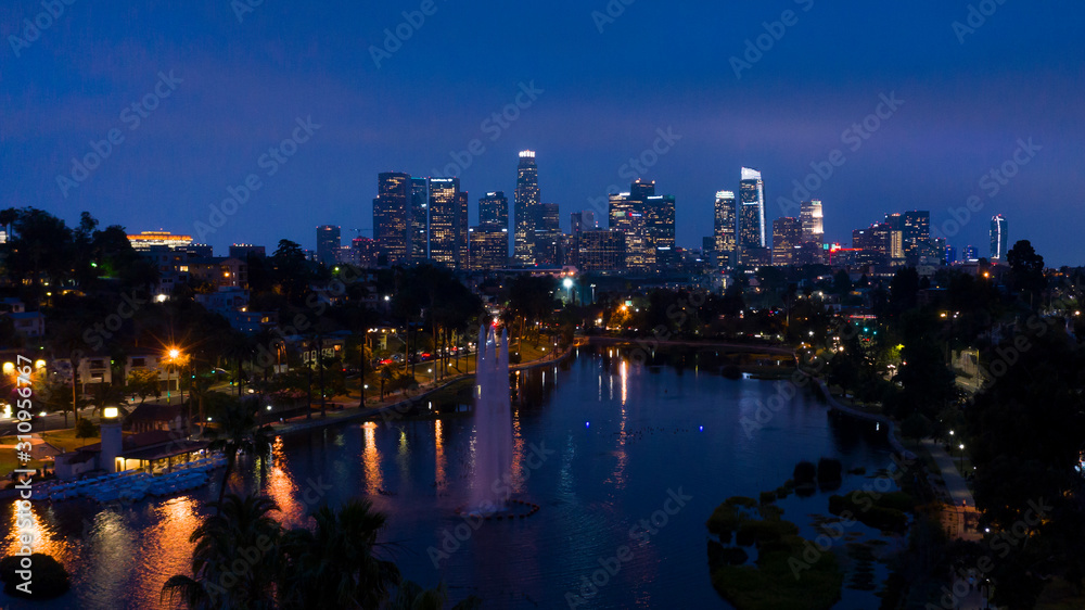 Naklejka premium JUNE 18, 2019, LOS ANGELES, CA, USA, Aerial of Los Angeles Skyline and Echo Park Lake at dusk