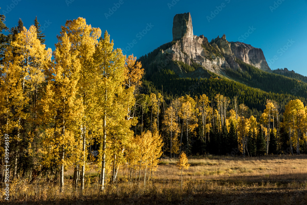 Courthouse Peak Mountain outside Ridgway Colorado shows Cimarron Mountains in autumn aspen colors