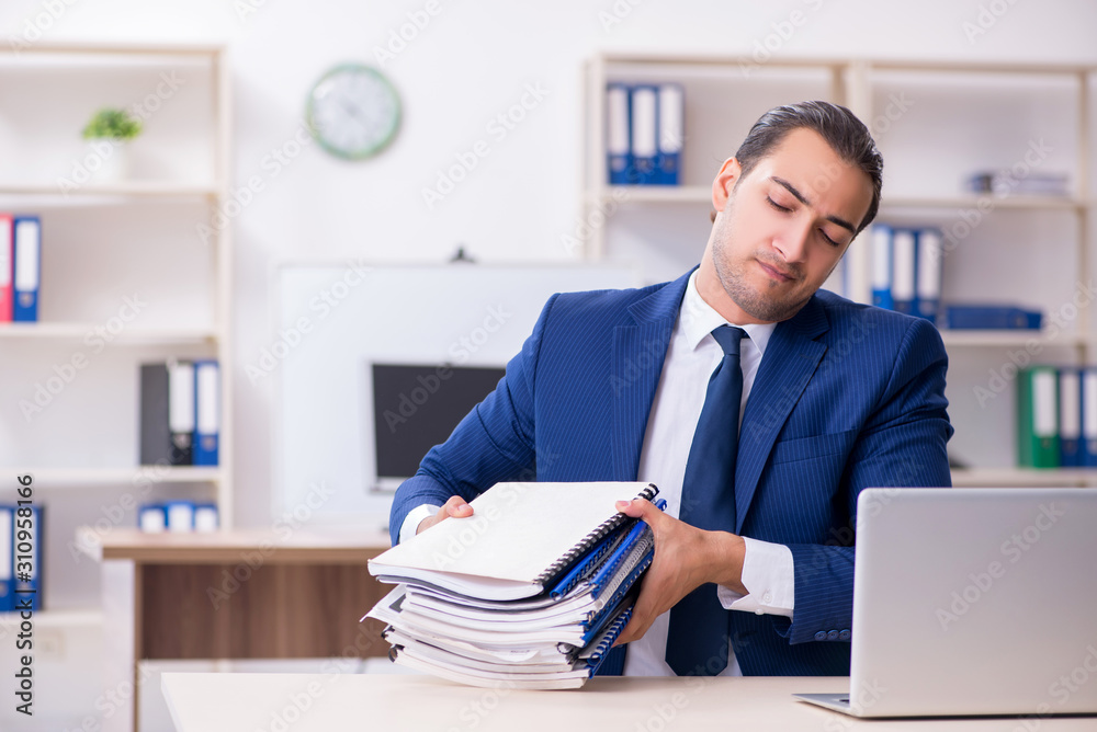 Young male businessman working in the office Young male businessman working in the office