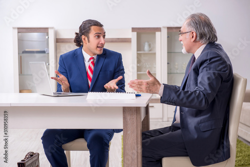 Two businessman discussing business in office