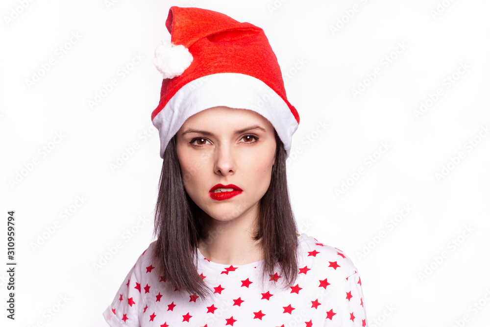 beautiful girl in a t-shirt with a star and a santa claus hat, with red lipstick on her lips