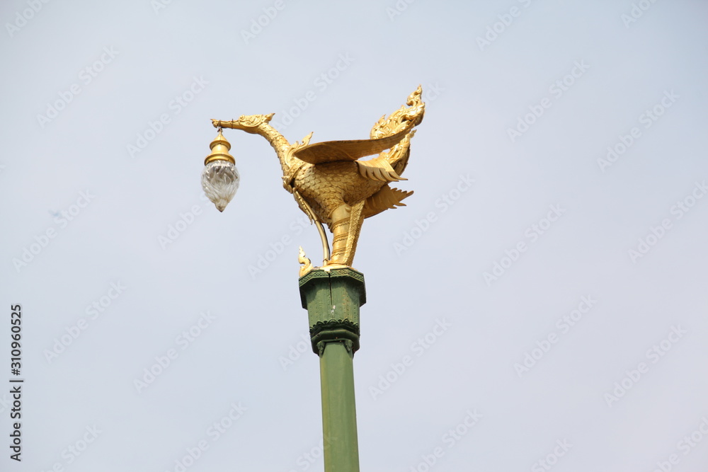 Golden bird lantern on the top of pole