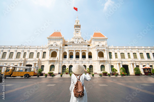 Woman tourist is traveling and sightseeing at Hochiminh people's committee hall landmark of Saigon, Vietnam.