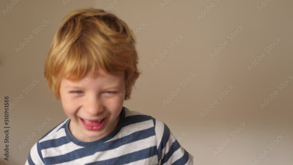Funny boy with milk tooth gap grimaces in front of the camera Funny boy with milk tooth gap grimaces in front of the camera