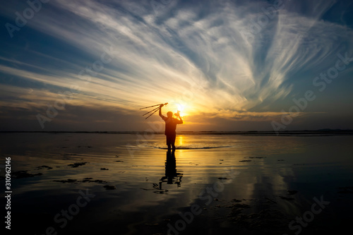 Silhuette men with sunrise sky at the lake. © noppharat