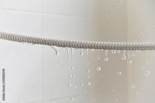 water drop  leaks from the shower hose in the bathroom