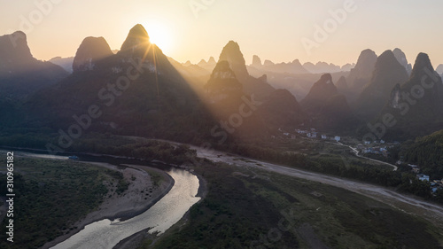 Aerial view of Xingping karsts hills and Li river at sunset near Yangshuo in Guanxi province, China © Fabio Nodari