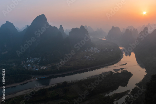 Sunrise over Xingping karsts hills in Xianggong hill and Li river at sunset near Yangshuo in Guanxi province, China photo