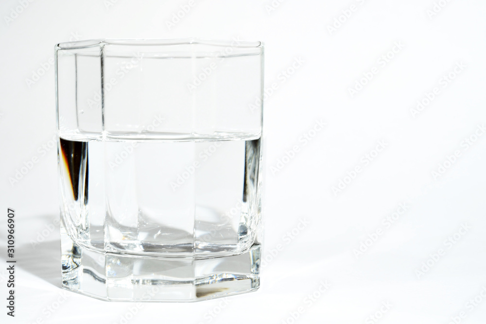 faceted glass with clear water or liquid faceted glass with clear water or liquid