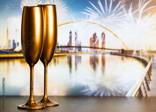 golden champagne glasses and fireworks  new year in Dubai photo