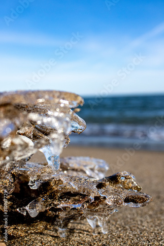 Sticker Frozen shapes of rock and sand in the beach in the winter