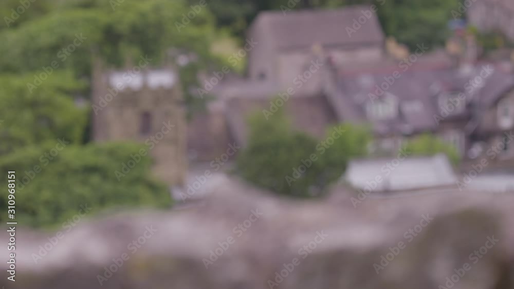 Close-up low angle still shot of cotton grass blowing in wind against the blue and white sky, countryside scene, Peak District, Derbyshire, UK