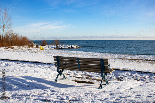 Lonely bench near the beach in the winter