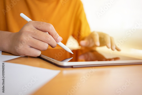 Business man , graphic designer or interior designer working with stylus pen using drawing digital tablet with home office.  Using smartphone tablet. Freelance Work, Business concept photo