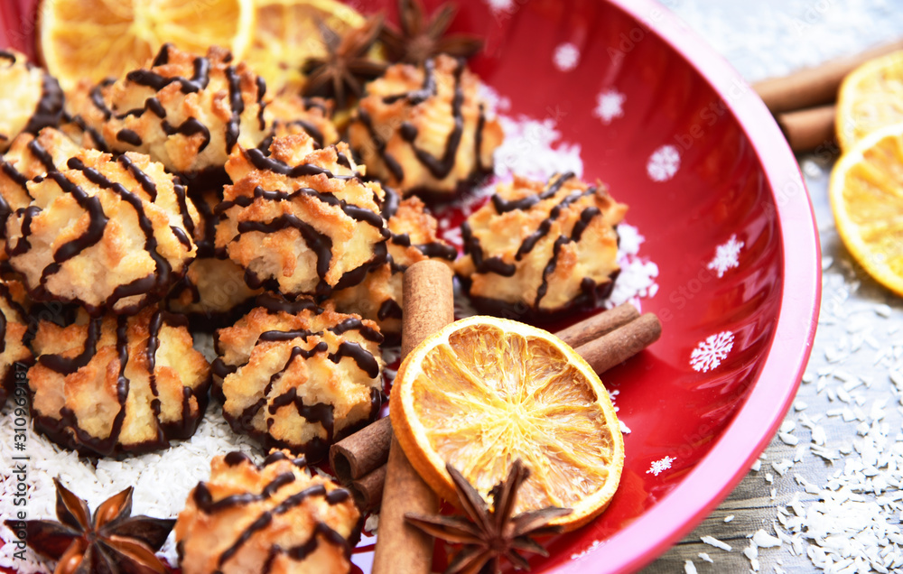 Fototapeta premium Coconut and Dark Chocolate cookies for Christmas Party with red tray and Christmas Decoration