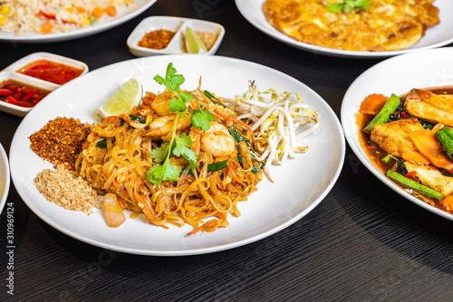 Pad thai or phad thai, is a stir-fried rice noodle, traditional dish served as a street food in Thailand. It is a stir-fry dish made with shrimp, chicken, peanuts, bean sprouts. Authentic Thai food.