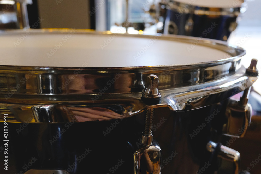 Fototapeta premium Close up of snare drum and blured tom background, Drumset is it a instruments for drummer musician, percussion rythm equipment. with selective focus