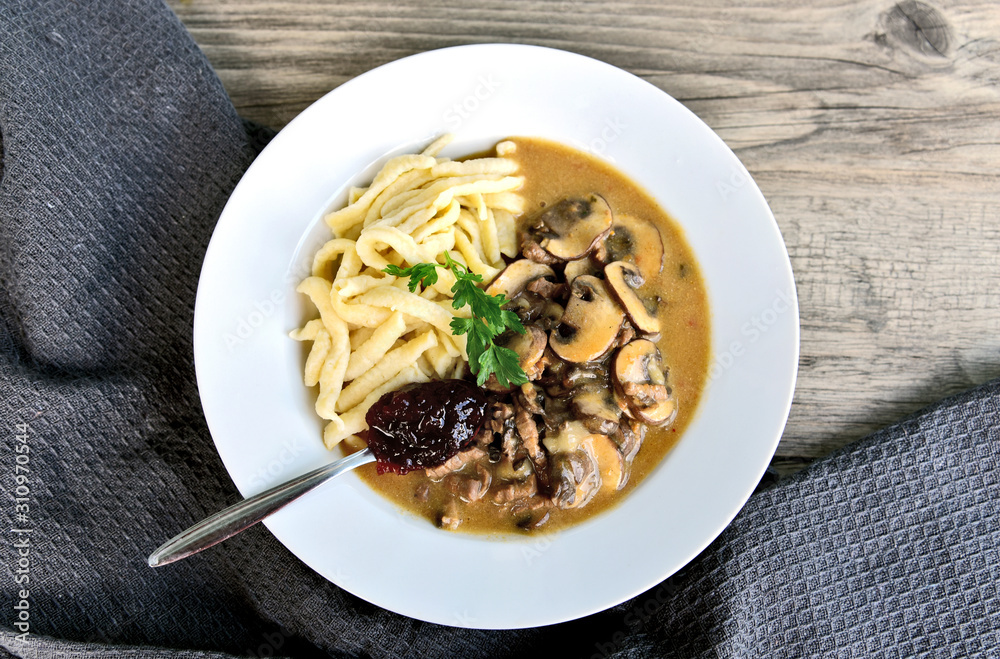 Brown button Mushroom slices Sour cream with soft egg noodle and wild cranberry jam.(German name is Champignon Rahm Geschnetzeltes mit Spätzle und Preiselbeermarmelade) Brown button Mushroom slices Sour cream with soft egg noodle and wild cranberry jam.(German name is Champignon Rahm Geschnetzeltes mit Spätzle und Preiselbeermarmelade)