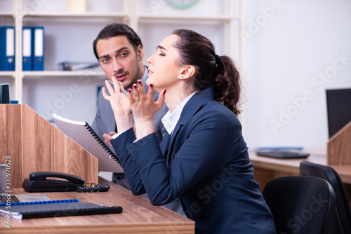 Two employees working in the office