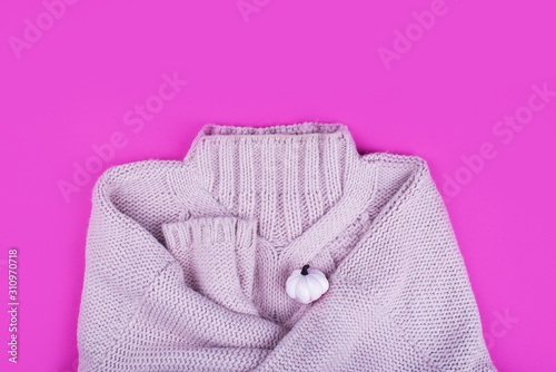 Soft soft pink sweater large viscous, with headphones for music on a bright pink background. Content