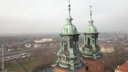 Drone footage of old Cathedral located in Poland. Name of the city is Gniezno. photo