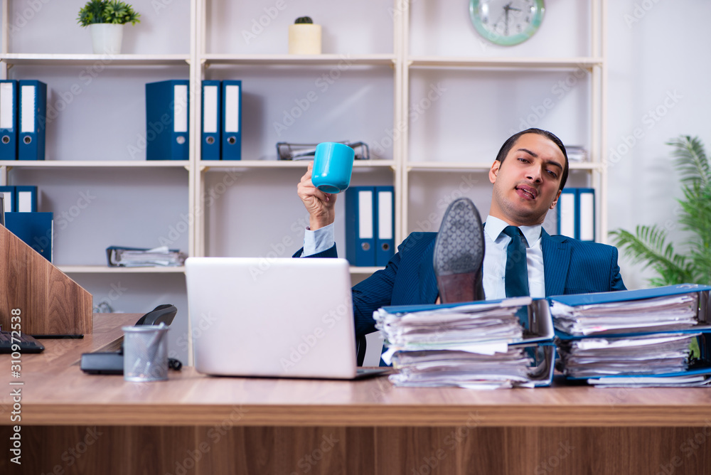 Young handsome businessman working in the office Young handsome businessman working in the office