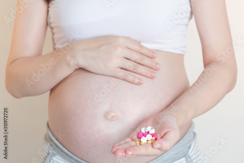 Wallpaper Mural Pregnant women with a pill and vitamin pills in the hand, Concept of pregnant women healthy and health care. Torontodigital.ca
