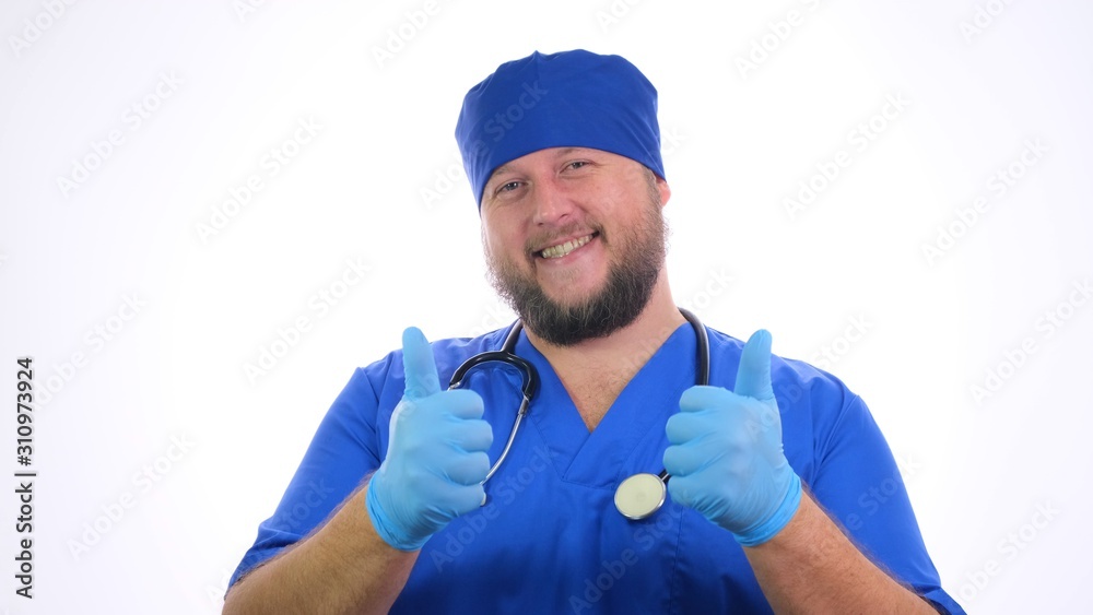 Bearded smiling male medical worker showing thumbs up sign.