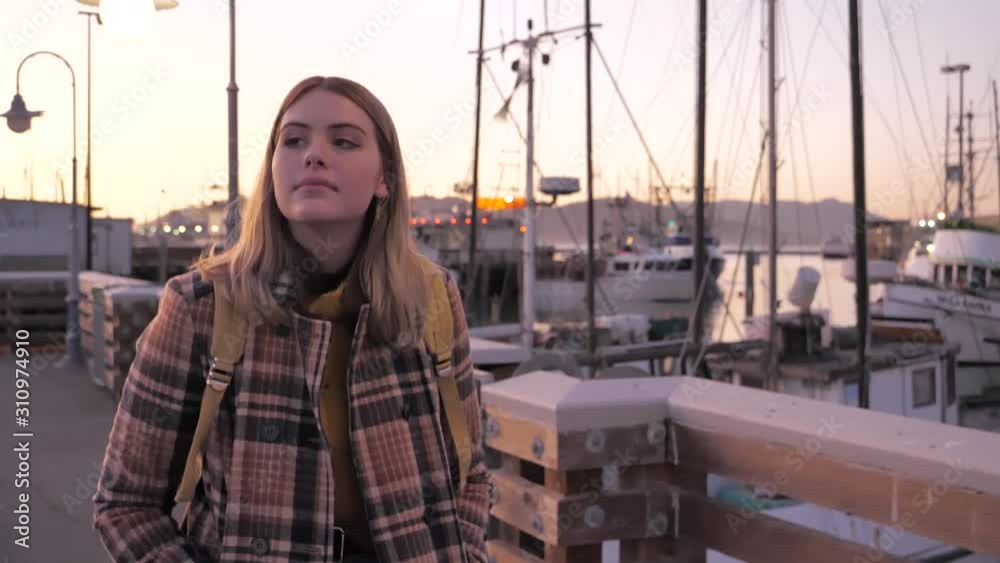 Young tourist girl millennial early 20s walking Fisherman's Wharf San Francisco