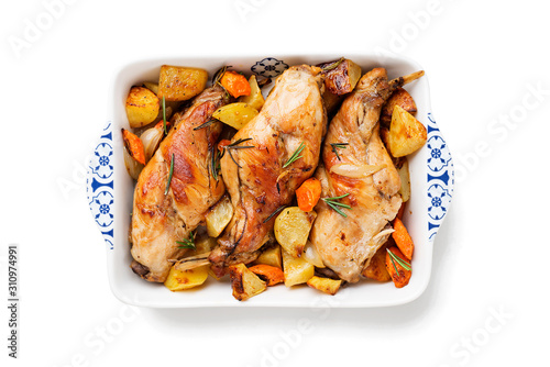 Stewed in white wine with spices rabbit legs with baked vegetables and rosemary. isolated on white background
