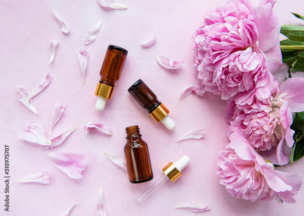 Aromatherapy essentials oils and pink peonies Aromatherapy essentials oils and pink peonies