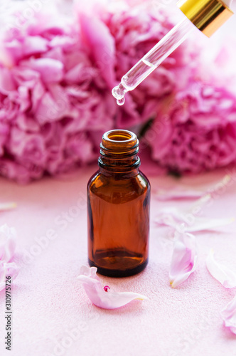 Aromatherapy essentials oils and pink peonies