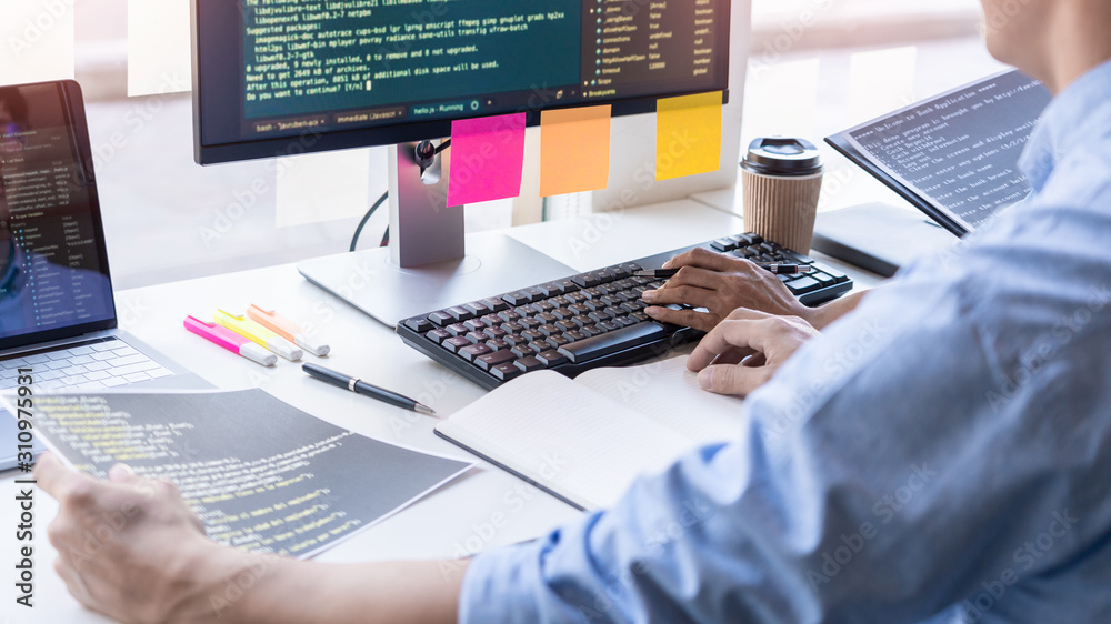 Pensive programmer working on on desktop pc programming code technologies or website design at office Software Development Company Pensive programmer working on on desktop pc programming code technologies or website design at office Software Development Company