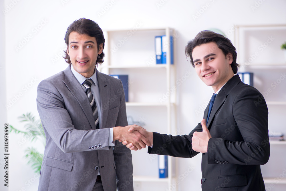 Two young businessmen meeting in the office Two young businessmen meeting in the office