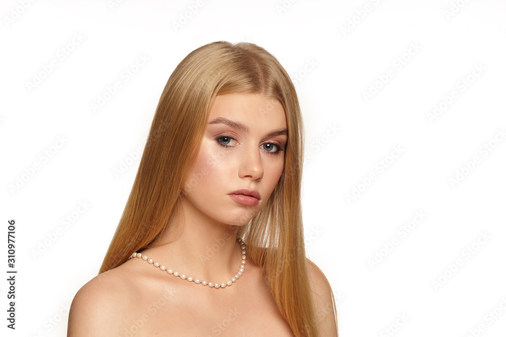Portrait of a young girl with natural make-up on a white background. Beautiful Spa Model Girl with Perfect Fresh Clean Skin. Youth and Skin Care Concept