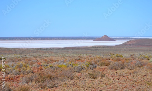 Open big clear blue sky landscape of the Australian outback desert with a salt lake and ancient volcanic island photo