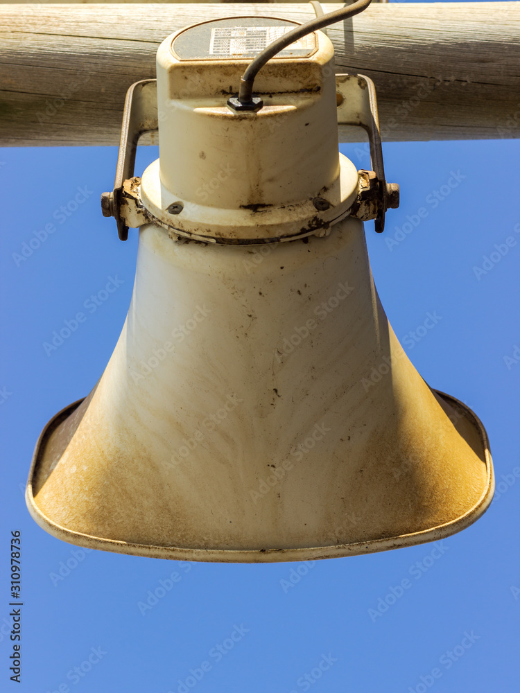 Fototapeta premium loud speaker, siren attached to a wooden pole
