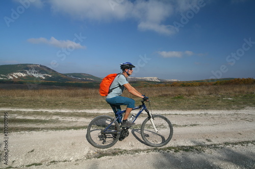 Cyclist on the background of the Crimean mountains, Russia.