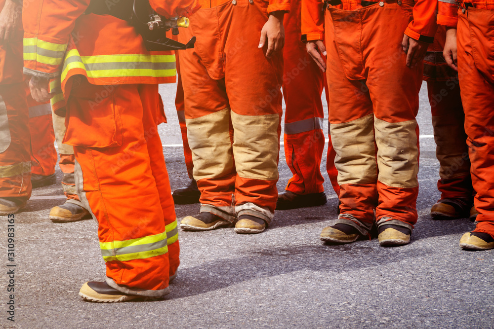 Fire fighter officers preparing to rescue, line of uniform for protection from flame Fire fighter officers preparing to rescue, line of uniform for protection from flame