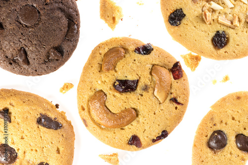 Top view of chocolate chips cookies and cashew nuts isolated on white background, flat lay of sweet and dessert with raisins seeds photo