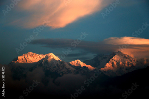 Kanchanjungha during golden hour, snow, peak, landscape, nature, Himalayan. Snowy mountains of Himalaya. A beautiful snowy mountain landscape under a blue cloudy sky..