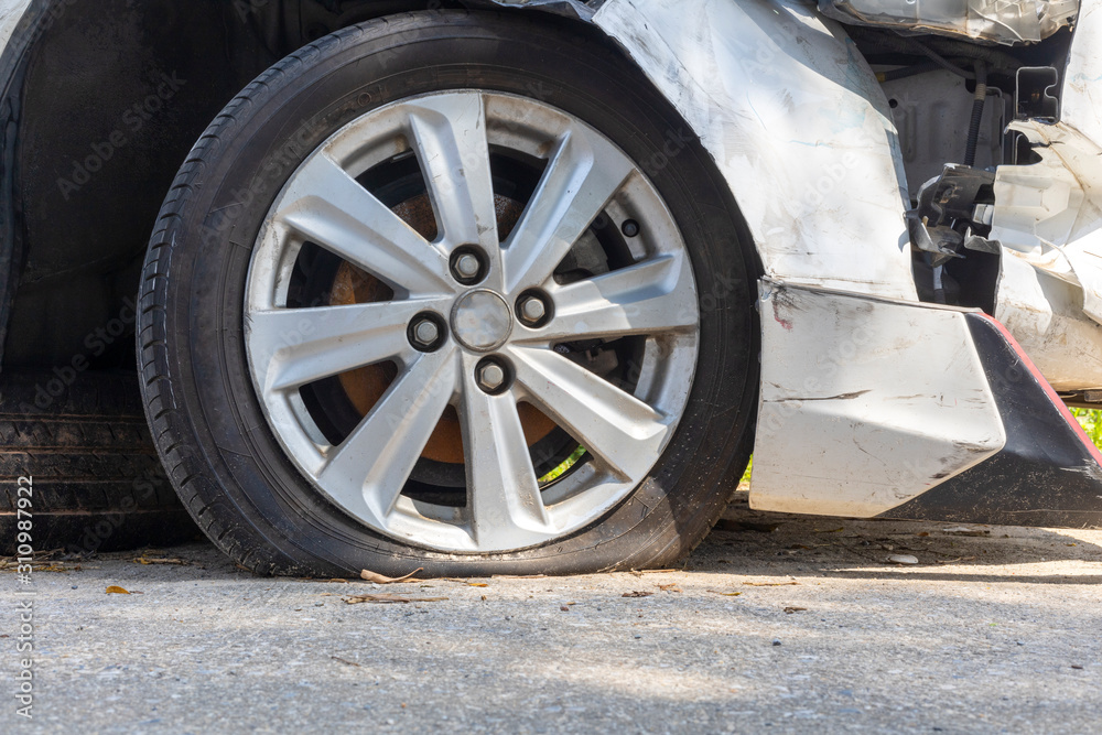 Broken tired, flat tire after front white car damaged and broken by accident isolated on white background. Save with clipping path.