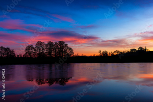 Fototapeta Naklejka Na Ścianę i Meble -  Sunset at czech countryside lake. Dramatic clouds.