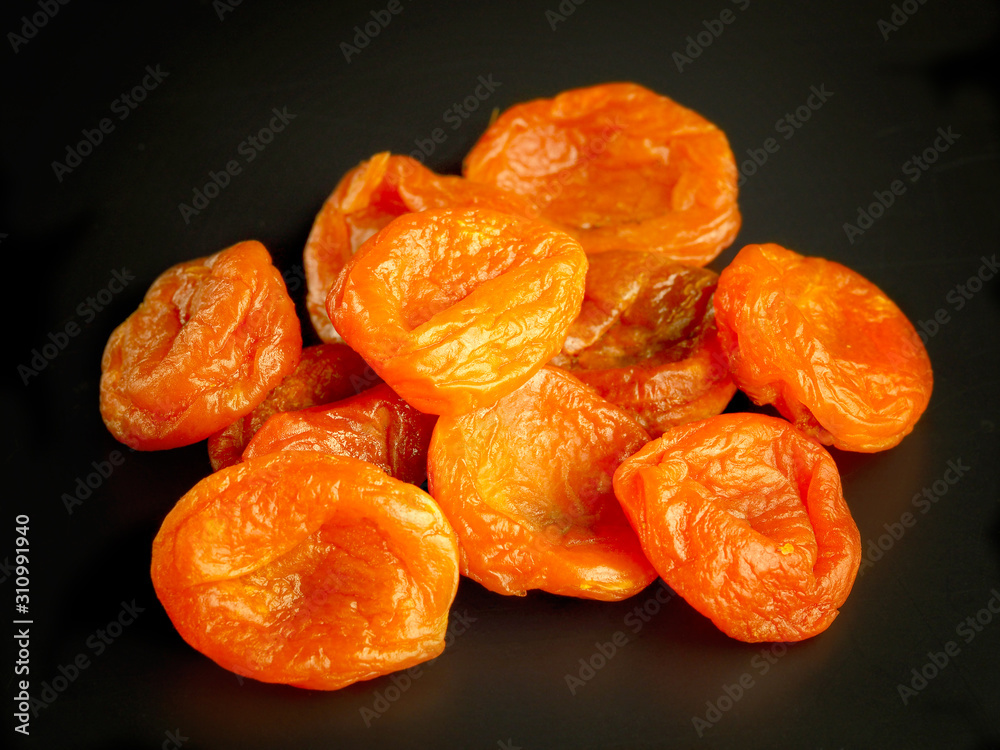 Sweet dried apricots on a dark background. Vitamins in the winter