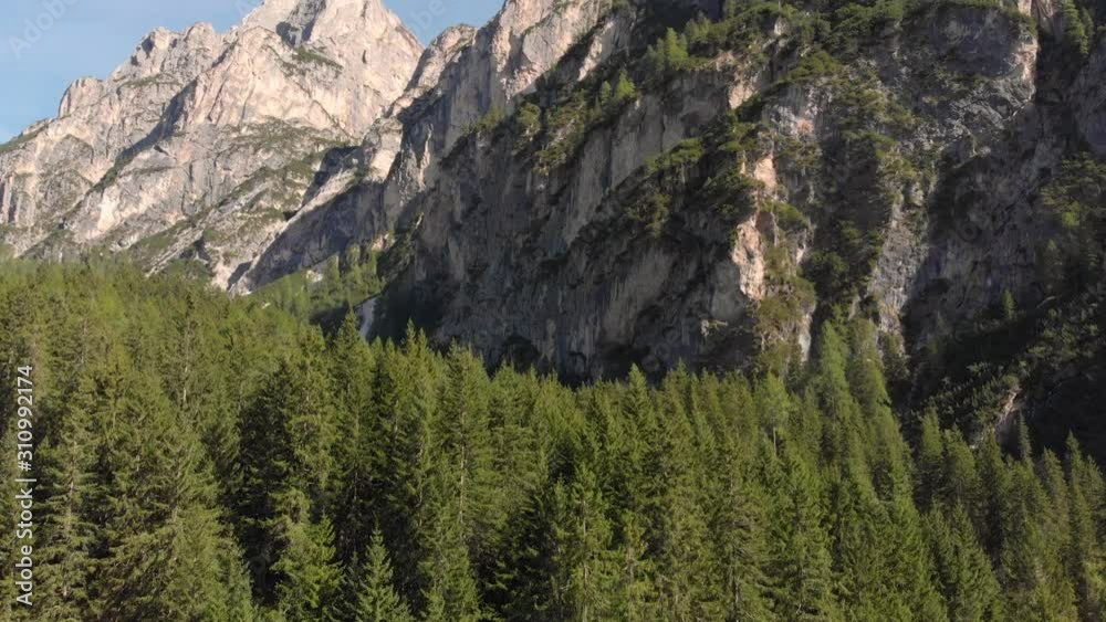 Lago Di Braies in the Dolomites. View of the forest and the mountain behind Lago Di Braies in the Dolomites. View of the forest and the mountain behind