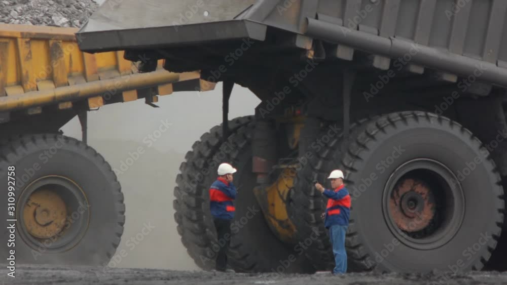Mining dump trucks in the open pit mine, heavy truck in coal mine Mining dump trucks in the open pit mine, heavy truck in coal mine