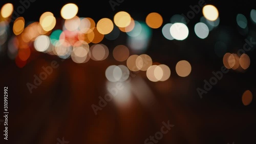 blurred light bokeh of cars moving on city street, abstract for background