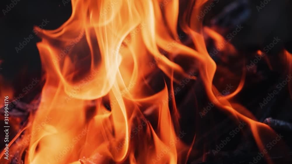 Slow motion of fire flame. Beautiful fire burns brightly. Burning logs in orange flame. Close-up. Slow motion of fire flame. Beautiful fire burns brightly. Burning logs in orange flame. Close-up.
