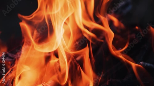Slow motion of fire flame. Beautiful fire burns brightly. Burning logs in orange flame. Close-up.